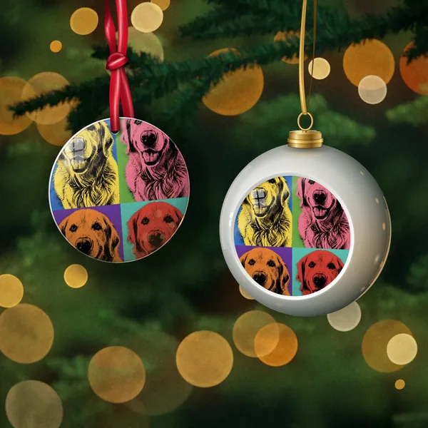 A metal ornament and a ceramic globe ornament with a pop art dog portrait, hanging on a Christmas tree
