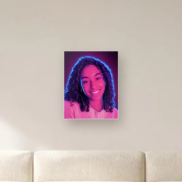 Glossy metal print of a neon portrait on a living room wall